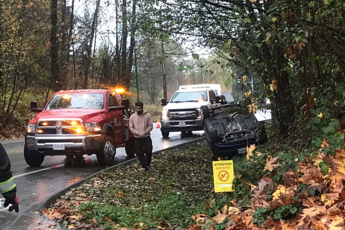Tow truck recovering a broken-down car on a London road